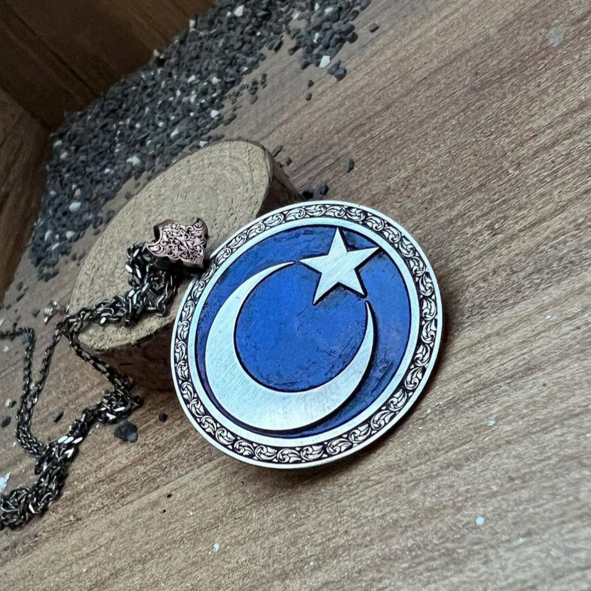 Moon and star medallion necklace on blue background – view 2