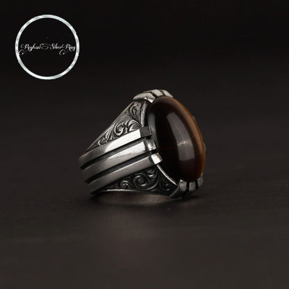 Oval claw-set tiger eye ring in 925 sterling silver